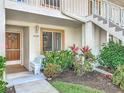 Inviting front entrance to the condo unit featuring a garden, bench, and stairs at 4382 Madeira Ct # 3361, Sarasota, FL 34233