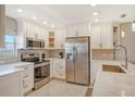 Updated kitchen featuring stainless steel appliances and white cabinetry at 9393 Midnight Pass Rd # 503, Sarasota, FL 34242