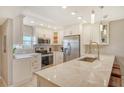 Modern kitchen with stainless steel appliances and white cabinets at 9393 Midnight Pass Rd # 503, Sarasota, FL 34242