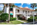Condo building exterior view with stairs and landscaping at 4382 Madeira Ct # 3361, Sarasota, FL 34233