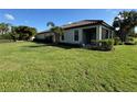House exterior showcasing a side entrance and screened patio at 8191 Varenna Dr, Sarasota, FL 34231