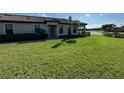 House exterior showcasing a front entrance and well-manicured lawn at 8191 Varenna Dr, Sarasota, FL 34231