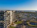 Beautiful condo building with ocean views, surrounded by palm trees and lush landscaping at 1055 Beach Rd # B-302, Sarasota, FL 34242