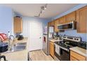 Efficient kitchen with stainless steel appliances and wood cabinets at 4850 51St W St # 5101, Bradenton, FL 34210