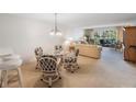 Bright dining area with glass table and four chairs at 6435 Egret Ln # 409, Bradenton, FL 34210