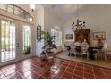 Bright dining room features a chandelier, tile floor, and wood table with seating for six at 8223 Regents Ct, University Park, FL 34201