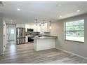 Modern kitchen with stainless steel appliances, granite countertops, and wood-look flooring at 5404 Dorsay St, Sarasota, FL 34232