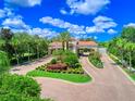 Gated entrance to the community with landscaping and flag at 4139 63Rd E Ter, Sarasota, FL 34243