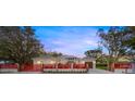 Modern house with red fence and landscaping at dusk at 4121 Bahia Vista St, Sarasota, FL 34232