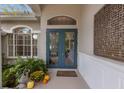 Elegant front entry featuring double doors and a decorative screen at 8223 Regents Ct, University Park, FL 34201