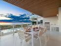 Oceanfront patio with dining area and grill at 4651 Gulf Of Mexico Dr # 402, Longboat Key, FL 34228