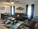 Comfortable living room featuring a large sofa, stylish rug, and ample seating at 6006 Hibiscus Dr # 6006, Bradenton, FL 34207