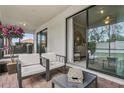 Relaxing screened patio with comfortable seating and view of backyard at 9869 Haze Dr, Venice, FL 34292
