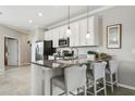 Modern kitchen with stainless steel appliances and granite countertops at 9869 Haze Dr, Venice, FL 34292