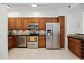 Modern kitchen with stainless steel appliances and wood cabinets at 4260 Central Sarasota Pkwy # 213, Sarasota, FL 34238