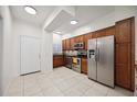 Modern kitchen with stainless steel appliances and wood cabinets at 4260 Central Sarasota Pkwy # 213, Sarasota, FL 34238