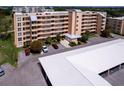 Tan multi-story building with parking and landscaping at 4550 Pinebrook Cir # 103, Bradenton, FL 34209