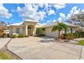 Tan house with tile roof, attached garage, and landscaping at 22324 Wexford Blvd, Venice, FL 34293