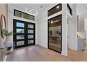 Bright entryway with modern double doors and hardwood floors at 1209 Blue Shell Loop, Sarasota, FL 34240