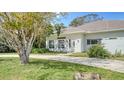 House exterior showcasing a walkway and mature trees at 1789 Loma Linda St, Sarasota, FL 34239