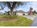 Tan, single-story home with two-car garage and American flag at 5525 Bountiful Dr # 20, Sarasota, FL 34233