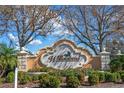 Elegant Willowbend community sign amidst lush greenery and mature trees at 650 Crane Prairie Way, Osprey, FL 34229