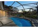 Screened-in pool area with water view, perfect for relaxing and entertaining at 650 Crane Prairie Way, Osprey, FL 34229