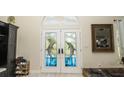 Double doors with stained glass dolphin accents at 6317 Werner Ave, New Port Richey, FL 34652