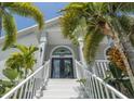 Front entry with stairs and tropical landscaping at 6317 Werner Ave, New Port Richey, FL 34652