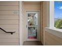 Inviting entryway with a glass storm door and welcome mat at 4802 51St W St # 1010, Bradenton, FL 34210