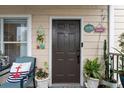 Inviting condo entry with nautical decor and potted plants at 4802 51St W St # 1010, Bradenton, FL 34210