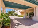 Covered building entrance with brick pavers and lush plants at 3070 Grand Bay Blvd # 632, Longboat Key, FL 34228