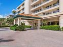 Elegant building entrance with covered walkway and landscaping at 3070 Grand Bay Blvd # 632, Longboat Key, FL 34228