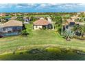 Aerial view showcasing the home's expansive lawn and the serene lake, perfect for outdoor relaxation at 6547 Willowshire Way, Bradenton, FL 34212