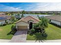 Charming home featuring a tile roof, a well-manicured lawn, and lush landscaping, providing great curb appeal at 6547 Willowshire Way, Bradenton, FL 34212