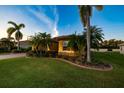 Beautiful Florida home with palm trees and landscaped lawn at 6935 74Th Street E Cir, Bradenton, FL 34203