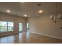 Spacious dining room with tile floors and modern light fixture at 890 Indus Rd, Venice, FL 34293