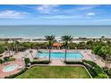 Resort-style pool with ocean view, lounge chairs, and a gazebo at 1241 Gulf Of Mexico Dr # 708, Longboat Key, FL 34228