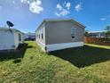 Side view of manufactured home with yard at 705 50Th Avenue W Dr, Bradenton, FL 34207