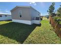 Rear view of manufactured home with AC unit at 705 50Th Avenue W Dr, Bradenton, FL 34207