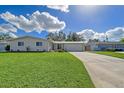 Updated single story home with a large grassy yard and attached garage at 3442 Fairview Dr, Sarasota, FL 34239
