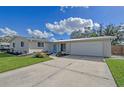 Updated ranch home with a two-car garage and well-maintained lawn at 3442 Fairview Dr, Sarasota, FL 34239