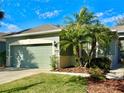 Charming one-story home featuring a two-car garage and lush front yard landscaping at 10444 48Th E Ct, Parrish, FL 34219