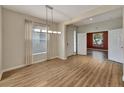 Open-concept living room featuring hardwood floors, large windows, and ample natural light at 10444 48Th E Ct, Parrish, FL 34219