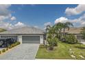 Two-story luxury home with a three-car garage and a nicely landscaped yard at 15967 Clear Skies Pl, Lakewood Ranch, FL 34211