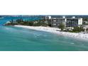 Aerial view of beachfront property with ocean and cityscape views at 19 Whispering Sands Dr # 201, Sarasota, FL 34242