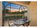 Enjoy outdoor dining with a beautiful lake view on this screened patio with seating at 7011 Woodmore Ter, Lakewood Ranch, FL 34202