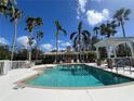 Resort-style pool and spa, surrounded by lush tropical landscaping and comfortable lounging areas for relaxation at 7011 Woodmore Ter, Lakewood Ranch, FL 34202