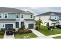 Two-story townhome with gray and blue exterior, two-car garage, and landscaped lawn at 11655 Bluestone Ct, Parrish, FL 34219
