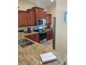 Well-equipped kitchen with granite countertops and wood cabinets at 11776 Angler'S Club Dr, Placida, FL 33946